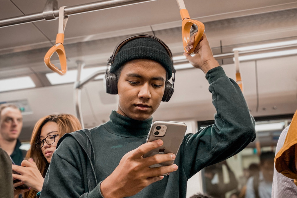 Man listening to music on the MRT