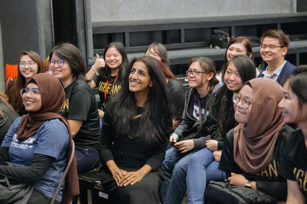 Dr Ayesha sitting with students of 21C