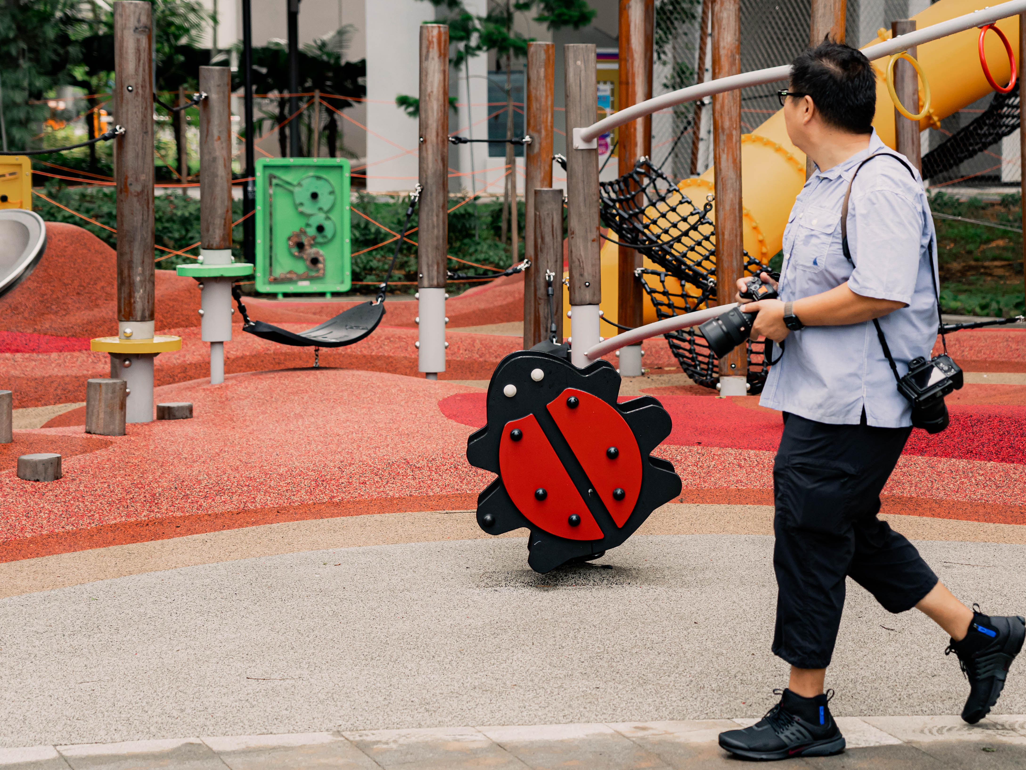 Darren walking past a playground