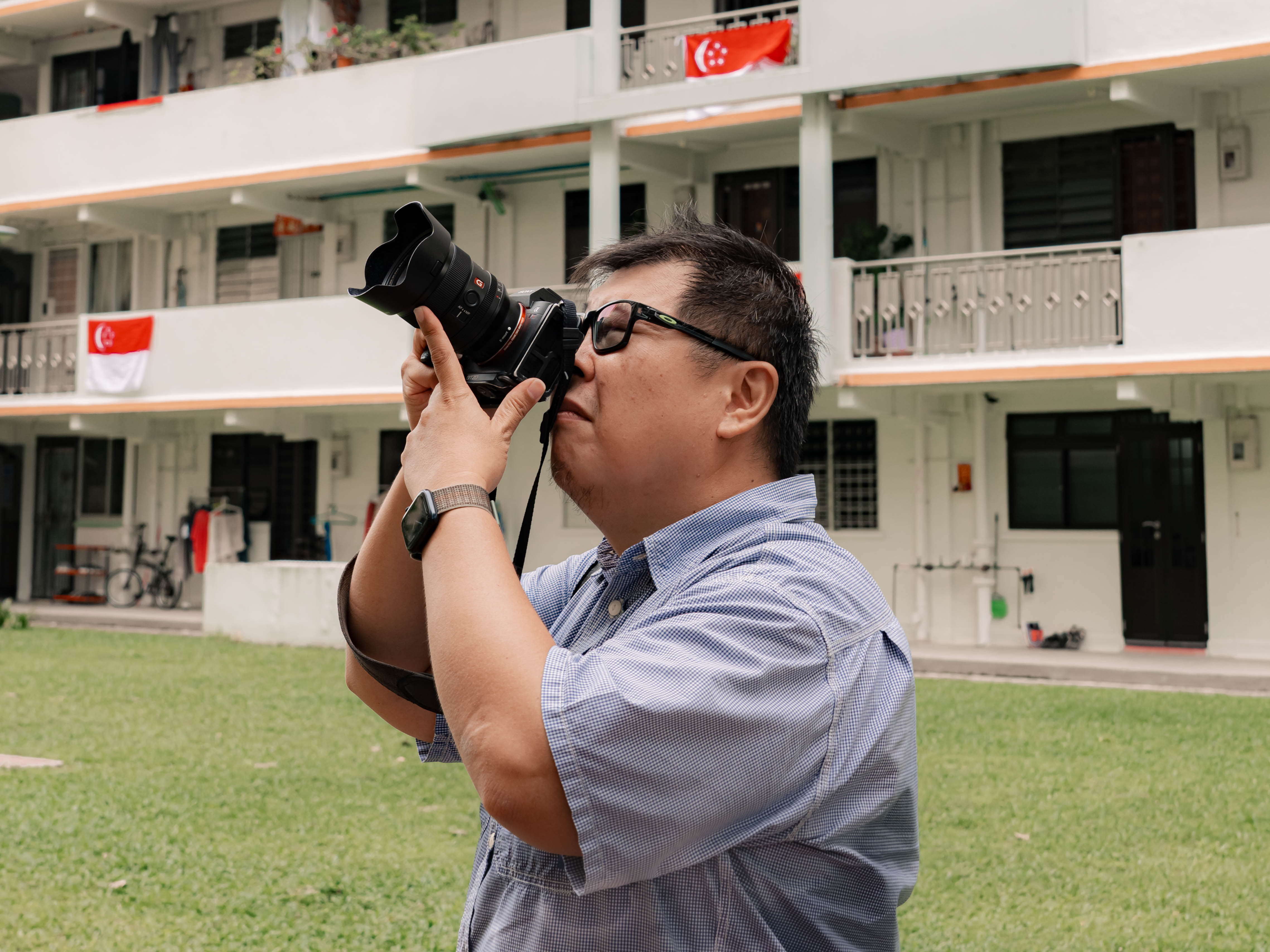 Darren aiming his lens at his iconic Commonwealth HDB block