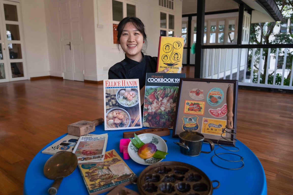 Yeo Min posing with her collection of cookbooks and traditional tools used for Chinese pastry.