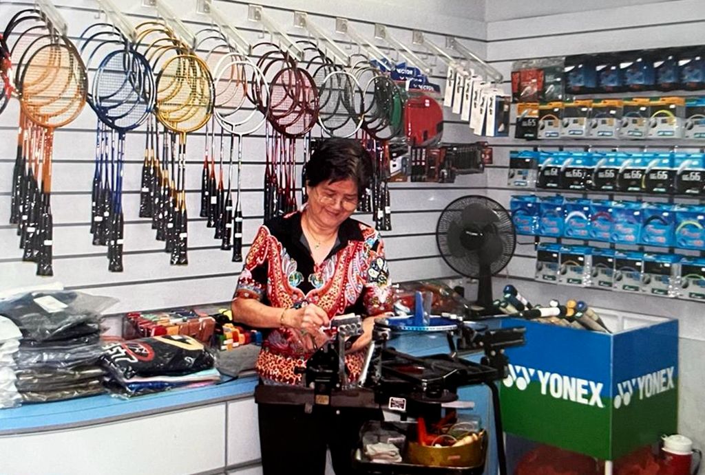 Derek’s Grandmother at their store stringing rackets