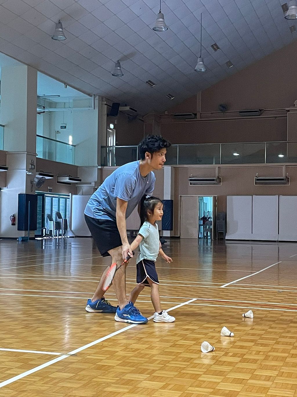 Derek coaching his daughter on how to hold the racquet, during their family exercise time