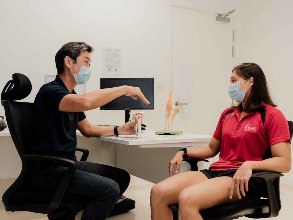 Dr Chew shares some injury prevention tips with Team Singapore athlete Nur Marina Chan